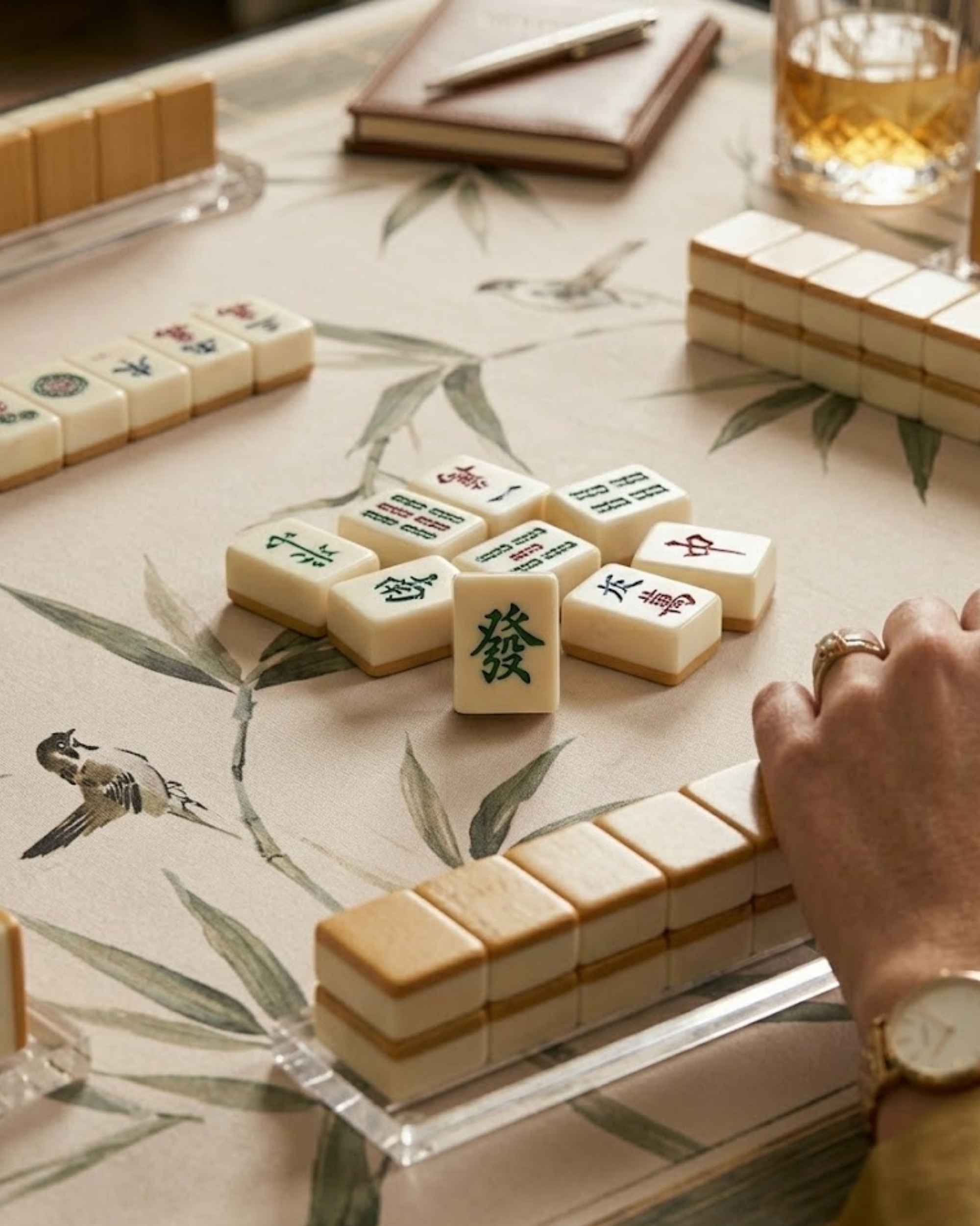 Close-up of cream bamboo-leaf mat with Mahjong tiles scattered near the edges