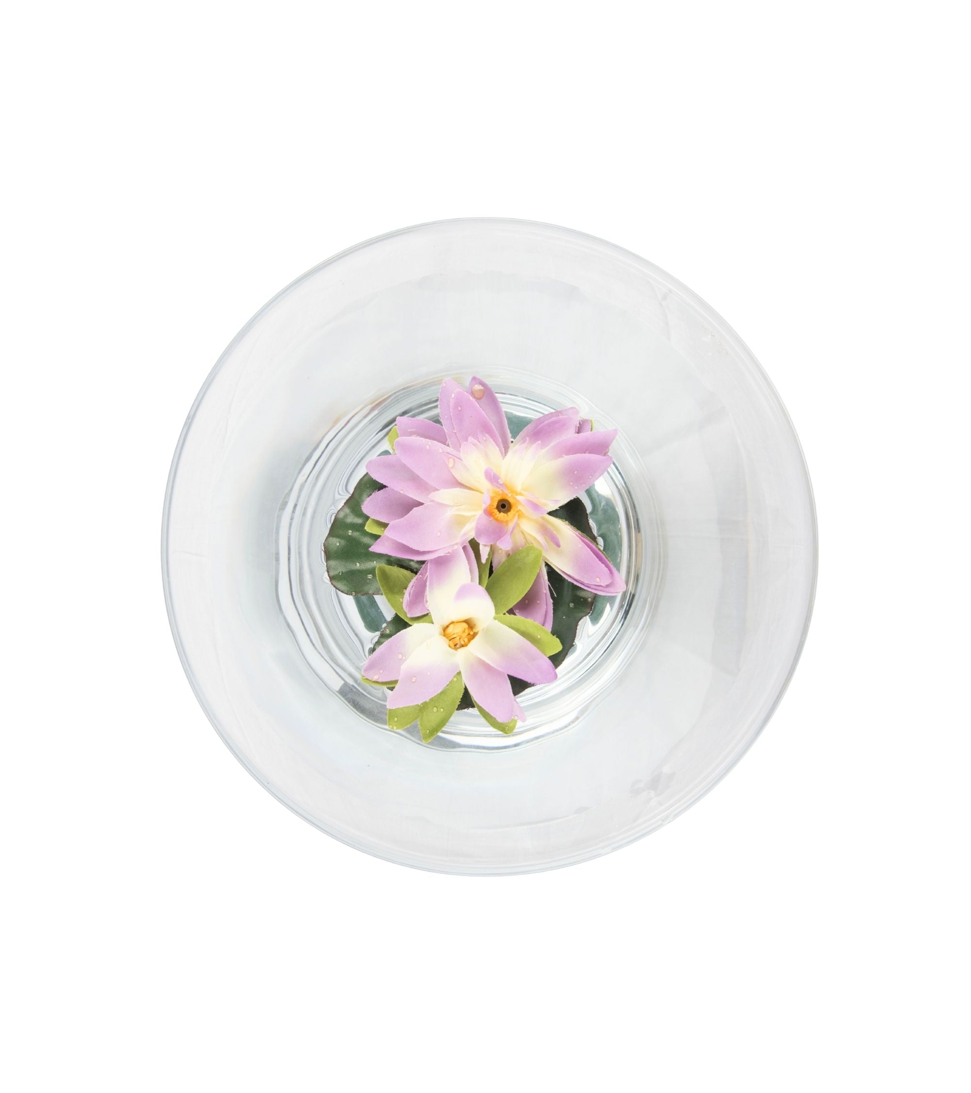 Top view: artificial purple lotus flower floating in clear round bowl