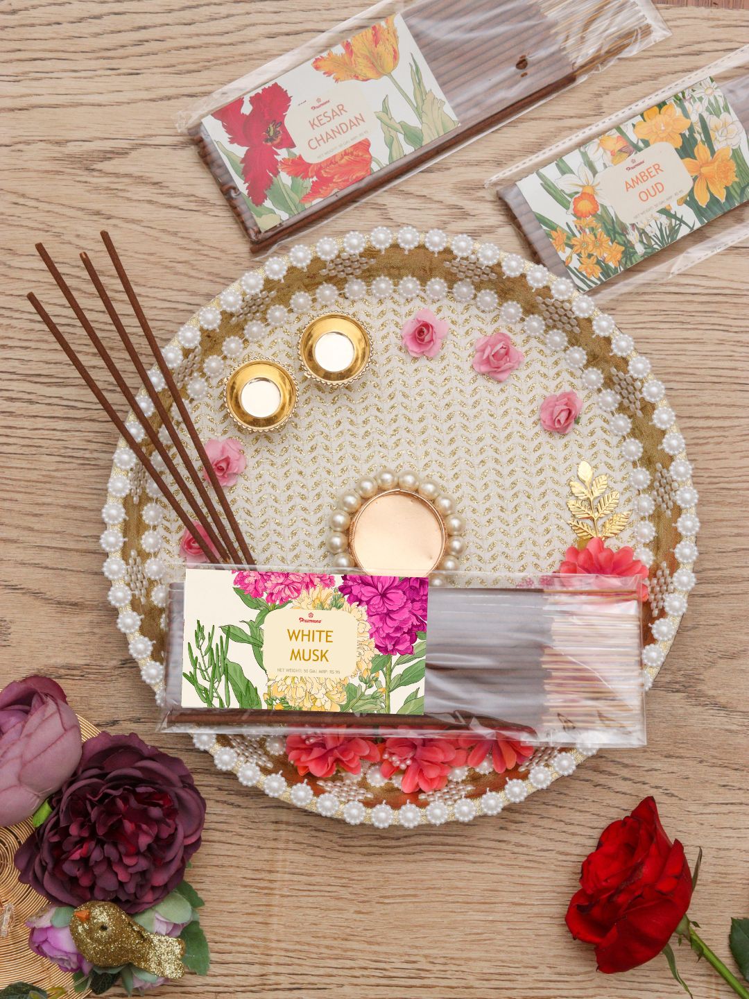 Fragrance incense sticks with floral box on beaded tray, brown sticks