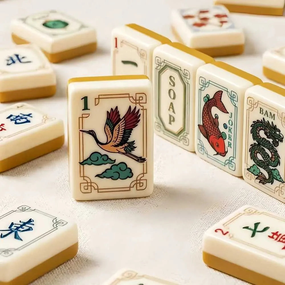 Mahjong tiles scattered, featuring numeric tiles and dragon/bird illustrated faces