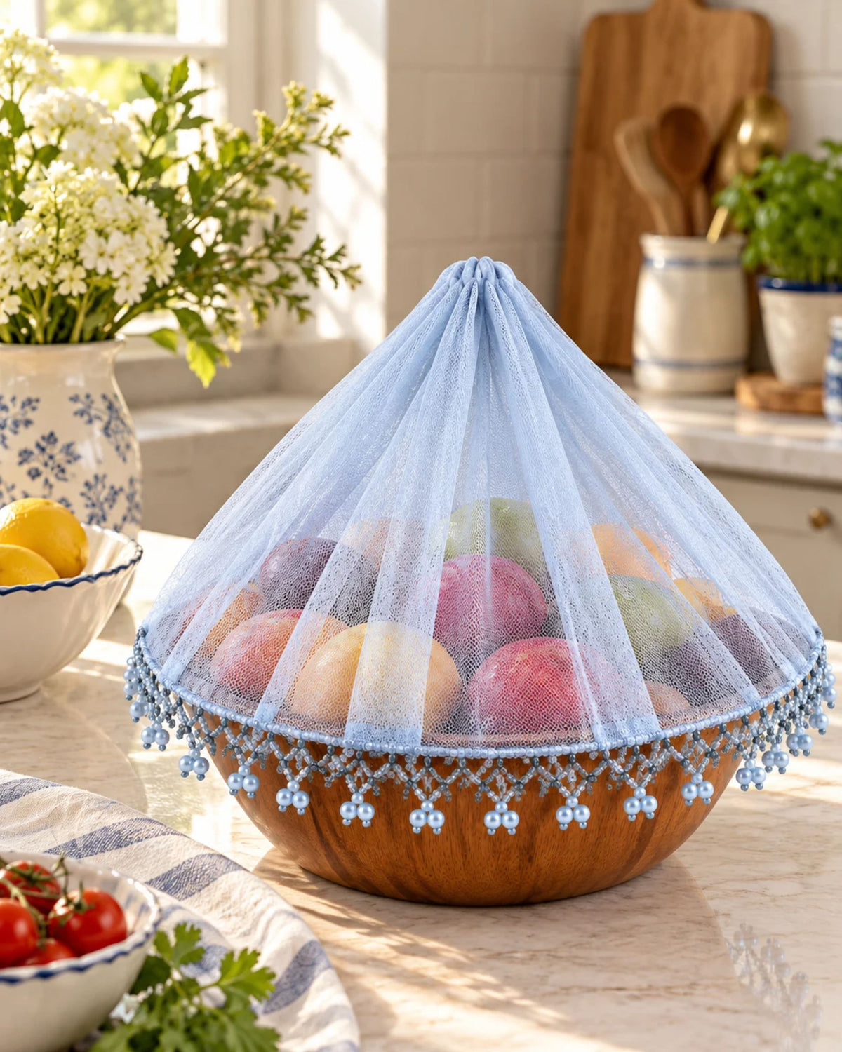 Light blue dome-shaped food cover with lace mesh and dangling bead trim.