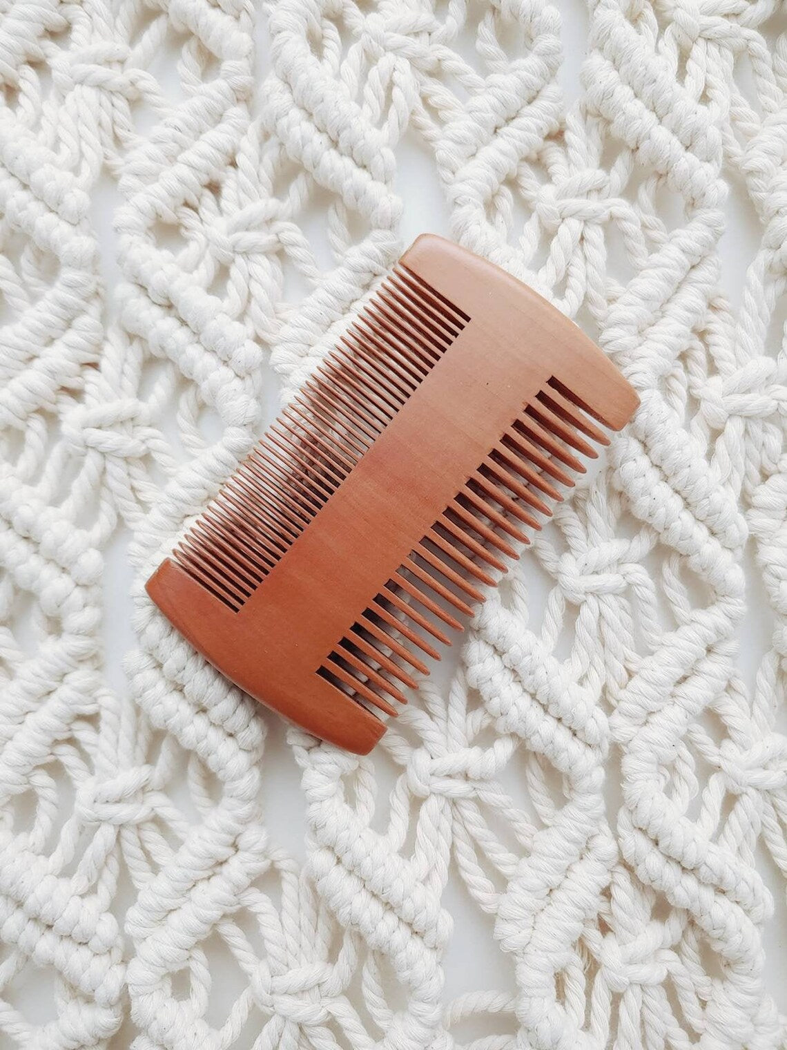Double-sided wooden hair comb with fine and wide teeth, top view