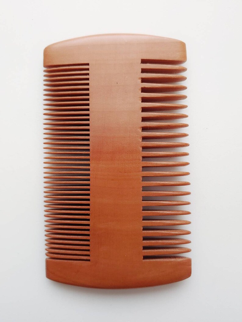 Double-sided wooden hair comb with fine and wide teeth, front view