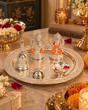 Silver-tone pooja thali set with Ganesha and Lakshmi figurines, bell, and small ritual bowls