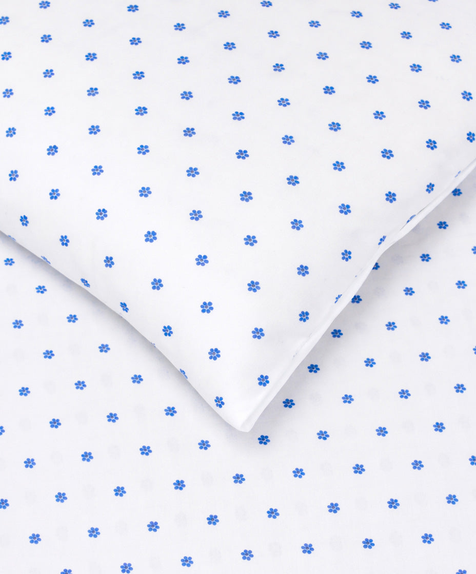 Blue mini flower print bedsheet corner detail on white fabric