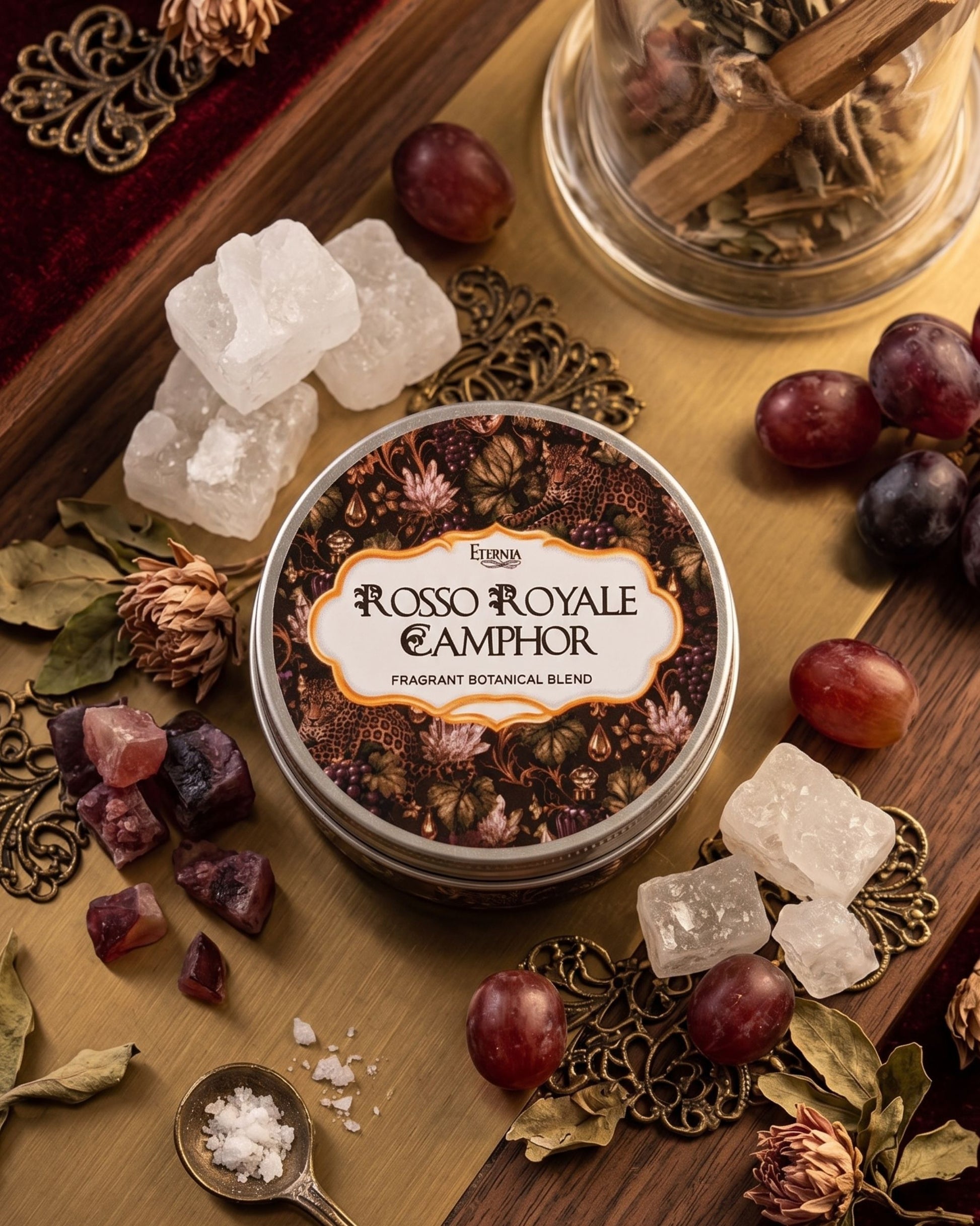 Fragrant camphor crystals in a glass jar with scattered crystal pieces and botanicals