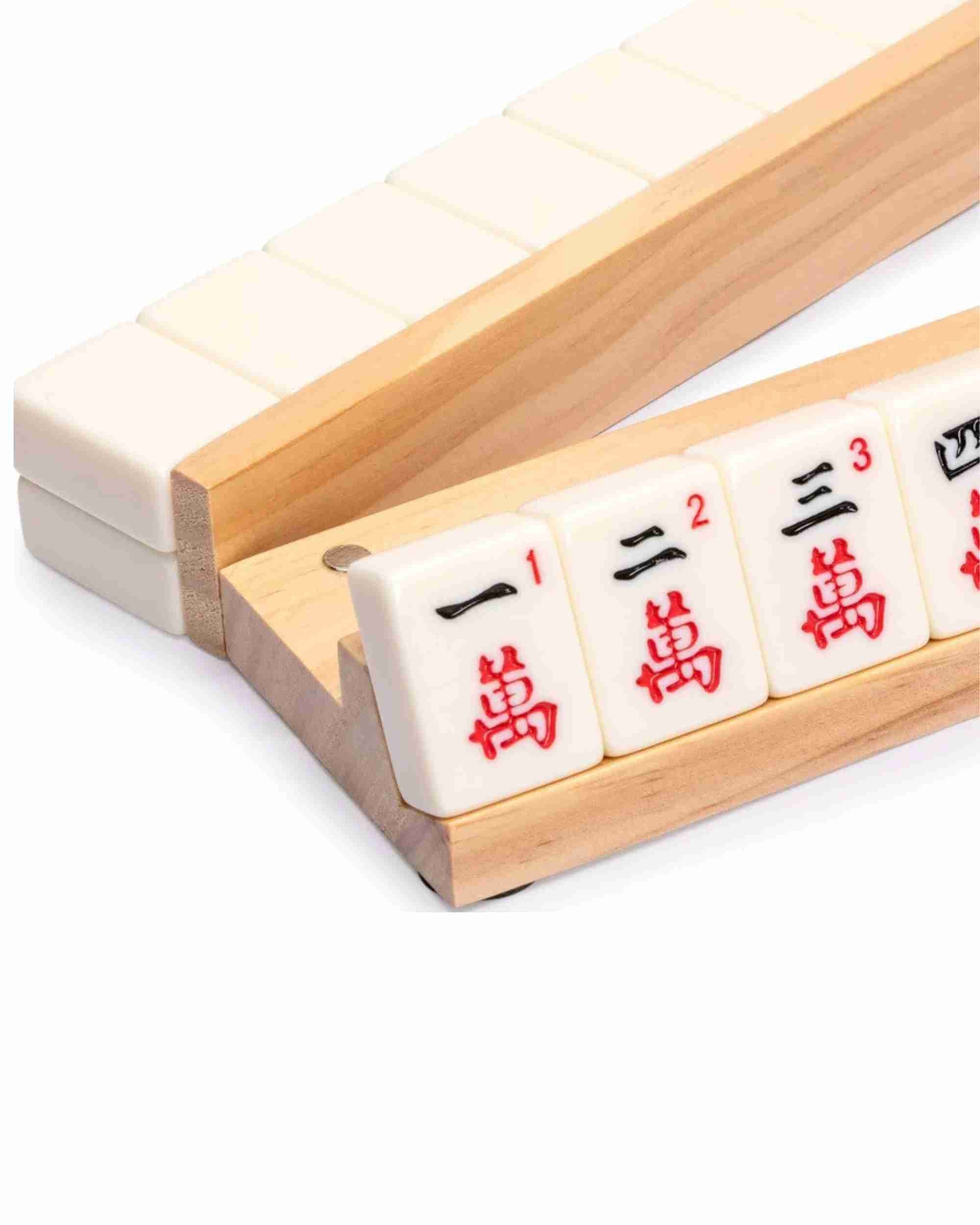 Wooden mahjong tile rack with tiles lined up, smooth light wood base